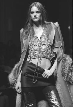 Gianfranco Ferré, fall/winter 2001-02 collection: silver sequined top and mini skirt under a fur-trimmed leather coat. © AP/Wide World Photos.