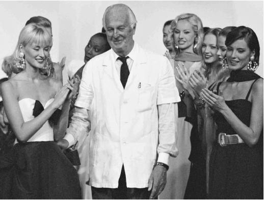 Hubert de Givenchy being applauded by his models at the last show before his retirement, the spring/summer 1996 ready-to-wear collection. © AP/Wide World Photos.