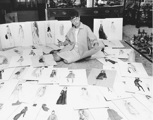 Edith Head surrounded by some of the 700 costumes she designed during her career, 1967. © AP/Wide World Photos.