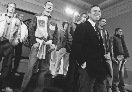 Tommy Hilfiger (foreground) posing with designs from his fall 2001 collection. © AP/Wide World Photos.